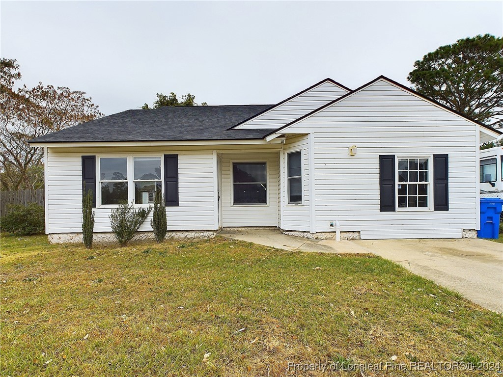 a view of a house with a yard and sitting area