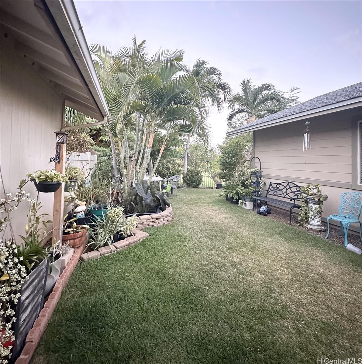 a backyard of a house with table and chairs