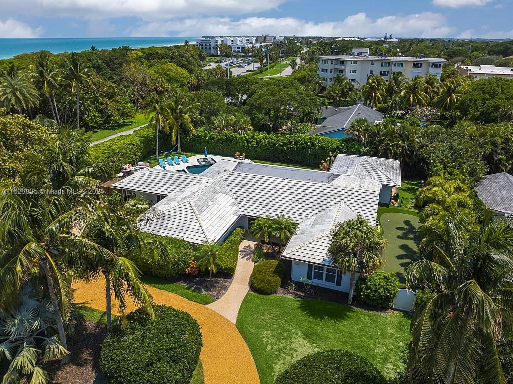 an aerial view of a house with a yard