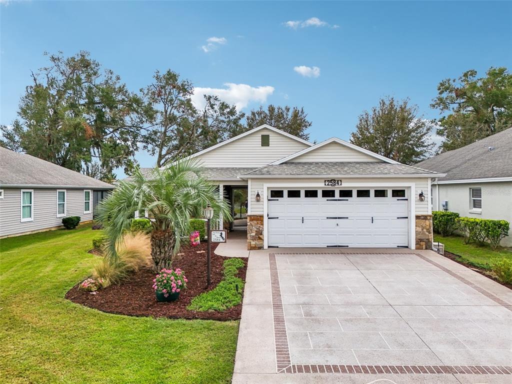 a front view of a house with a yard and garage