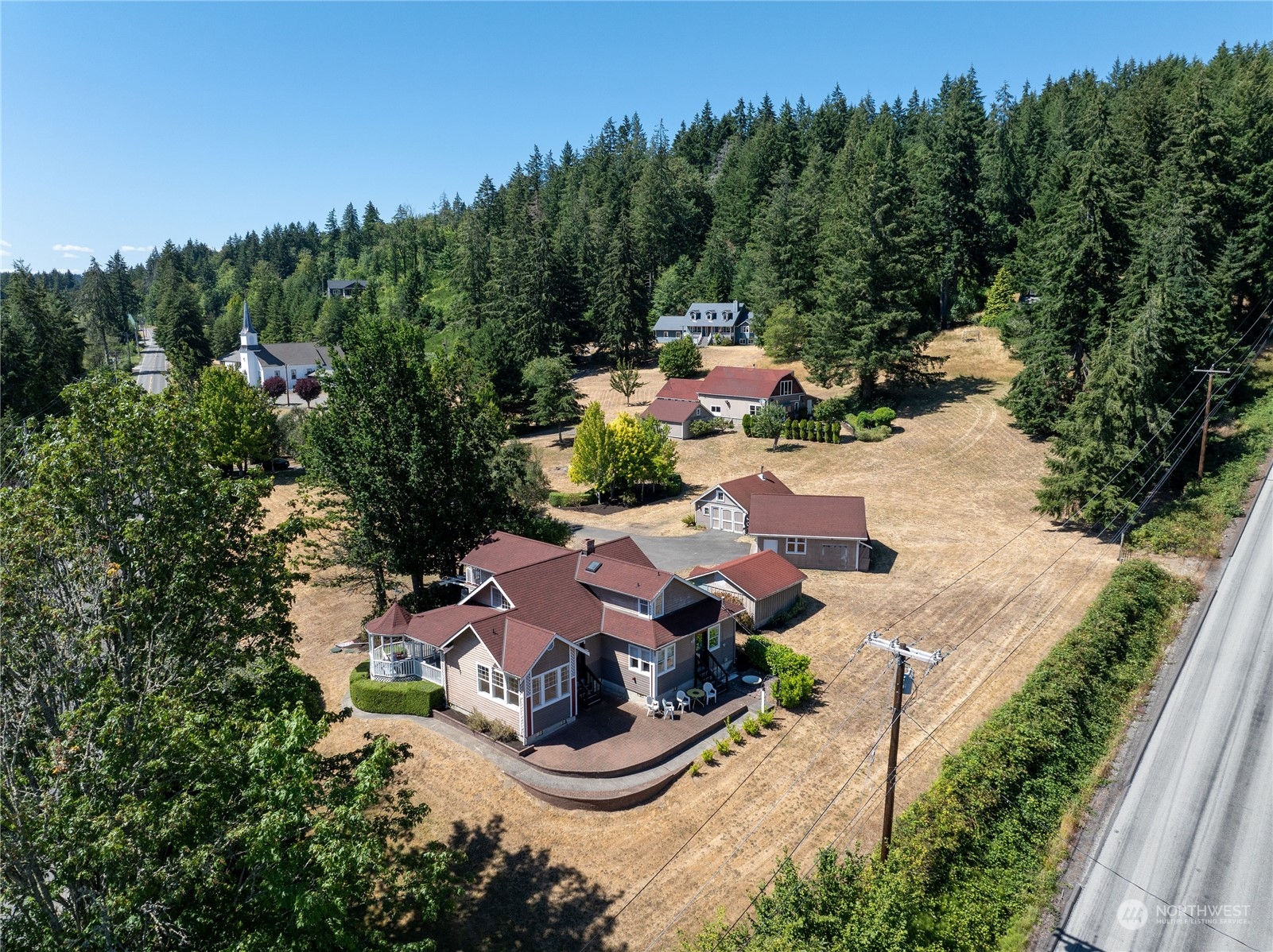 an aerial view of a house with garden space and street view