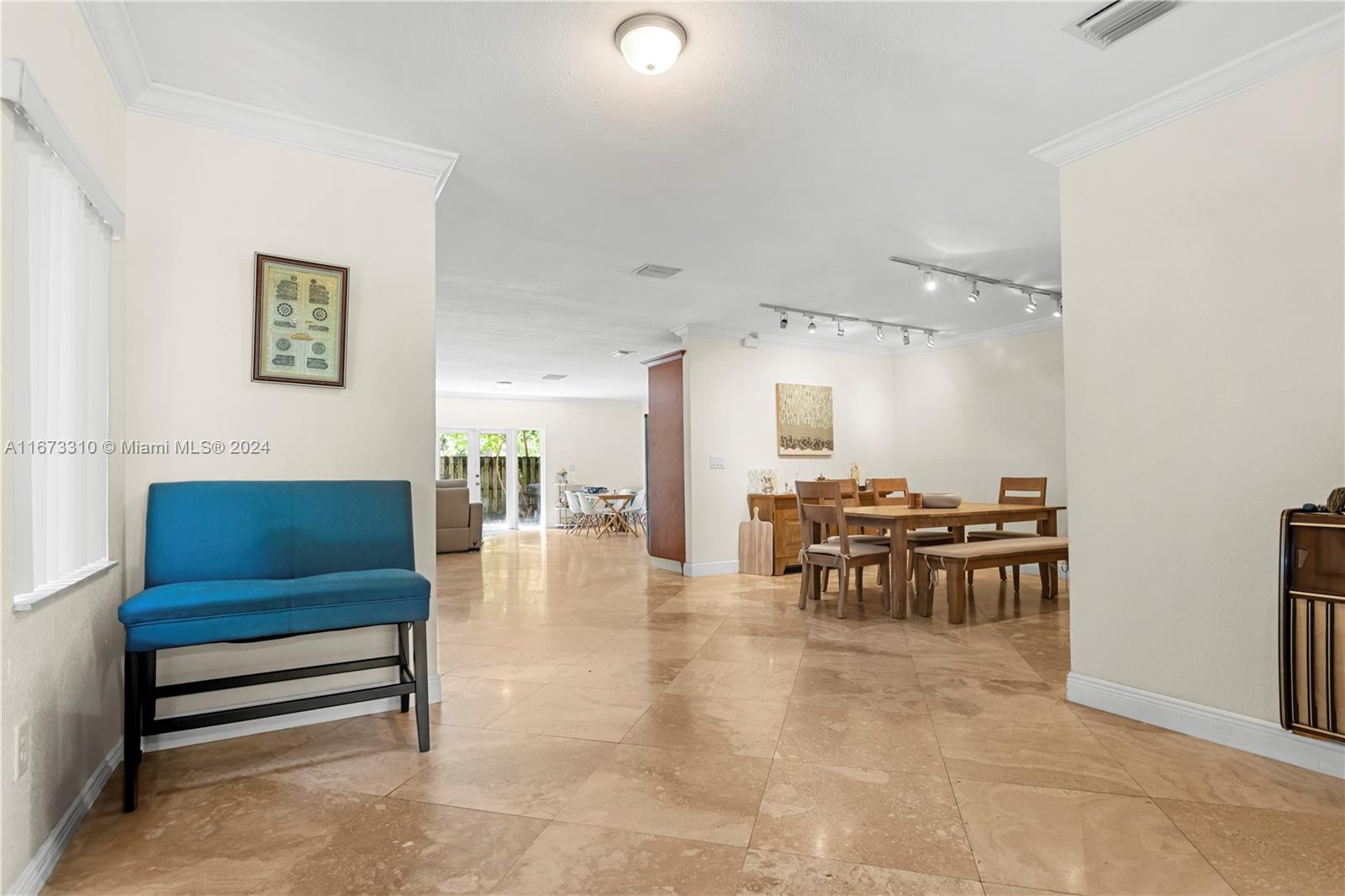 a living room with furniture and a dining table with kitchen view