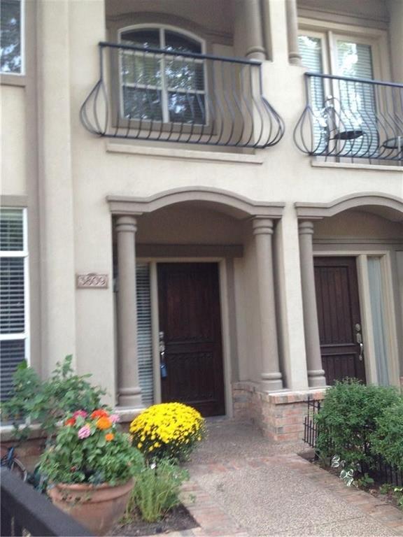 a front view of a house with plants