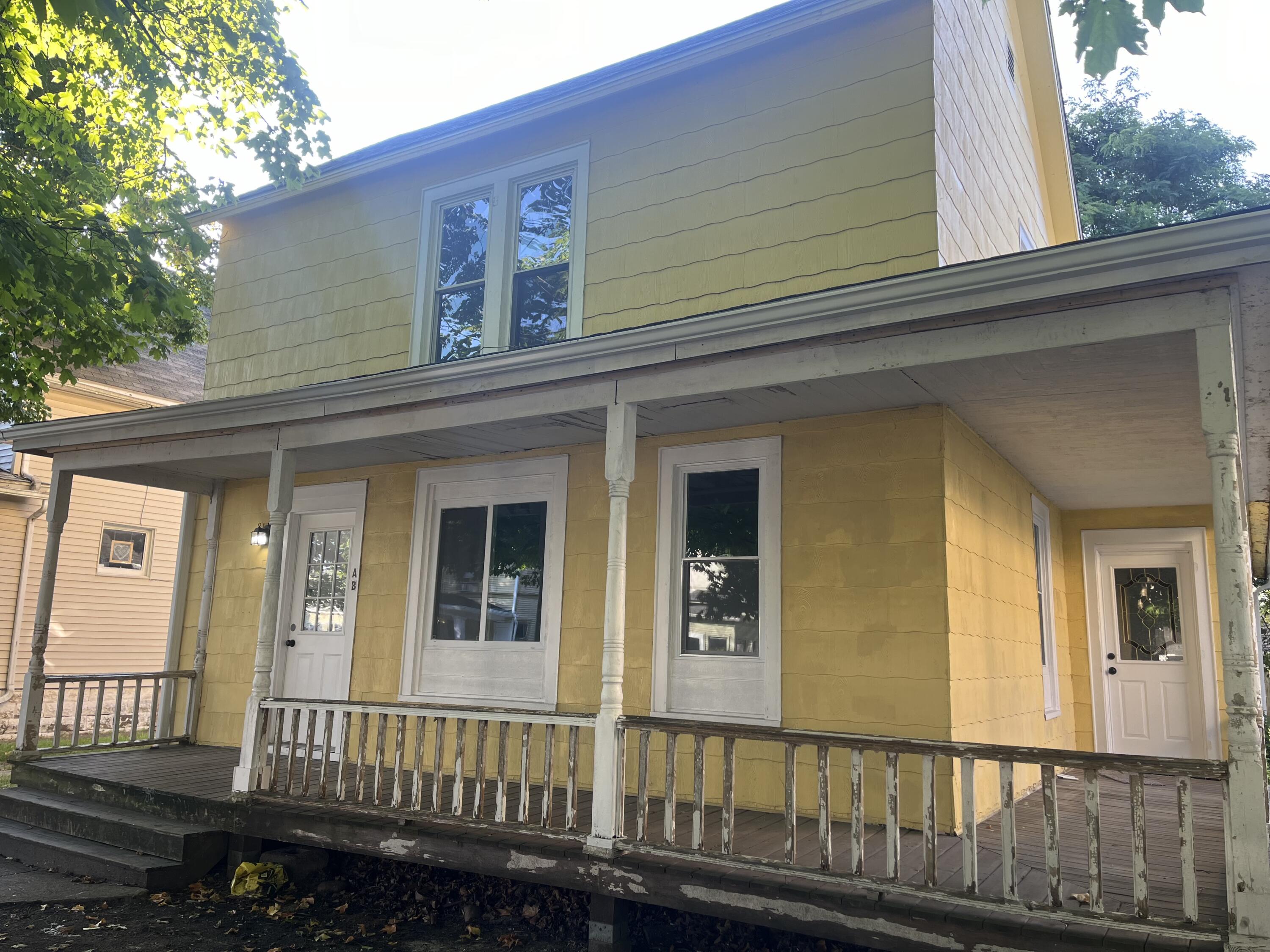 a view of a house with wooden fence