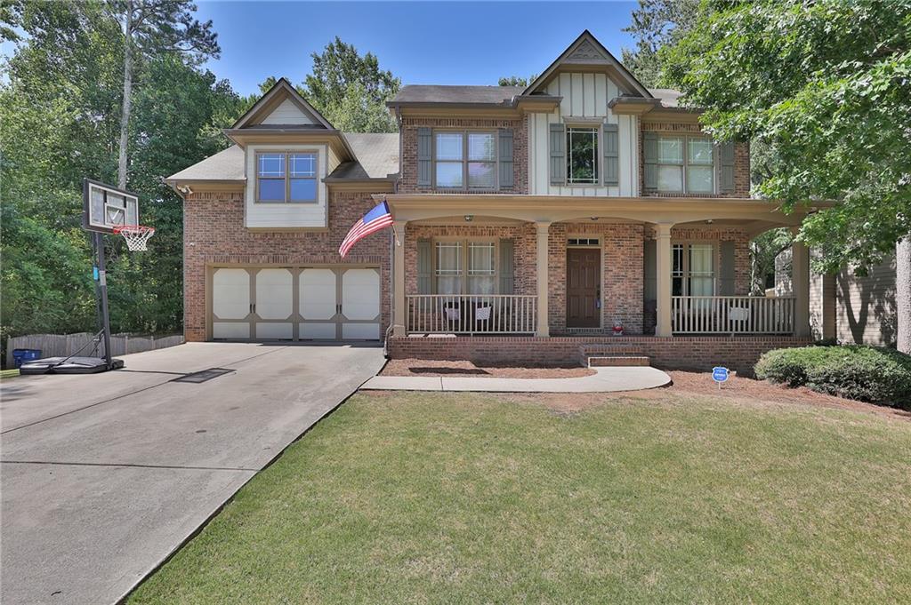 a front view of a house with yard and green space