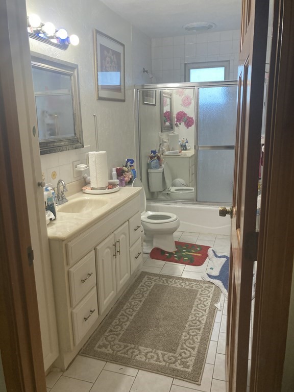 a bathroom with a sink toilet vanity and shower