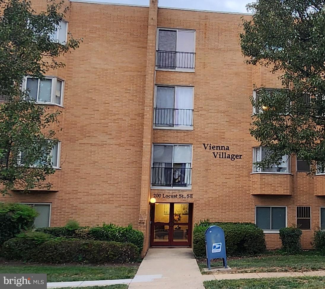 a front view of a brick building with large windows