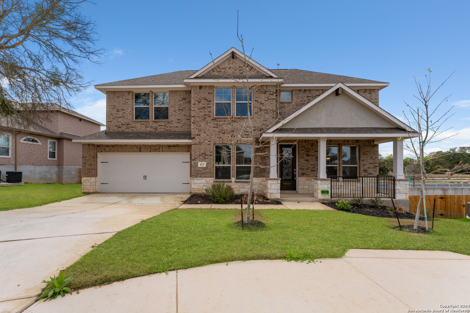 a front view of a house with a yard and porch