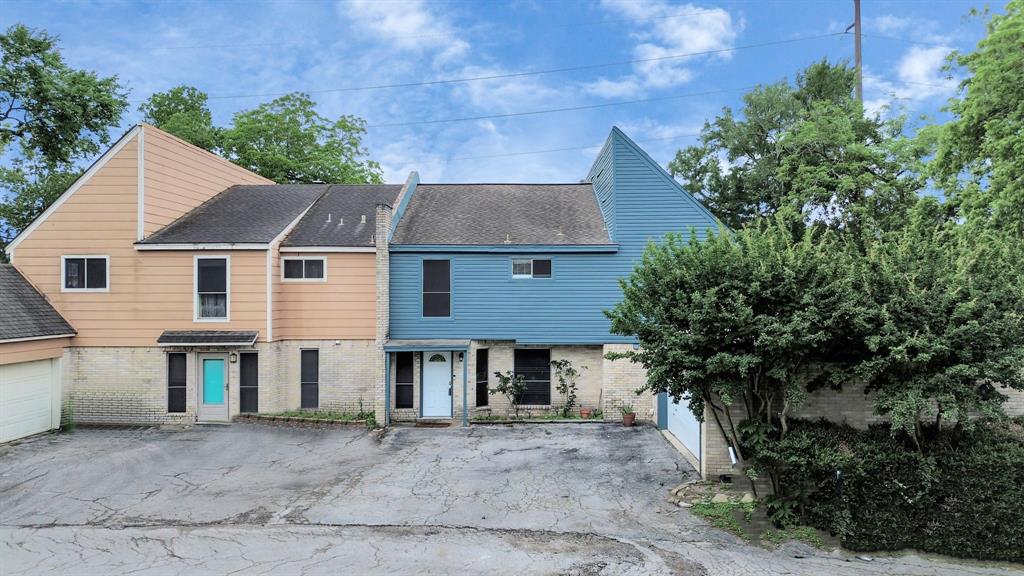 a aerial view of a house with a yard and plants