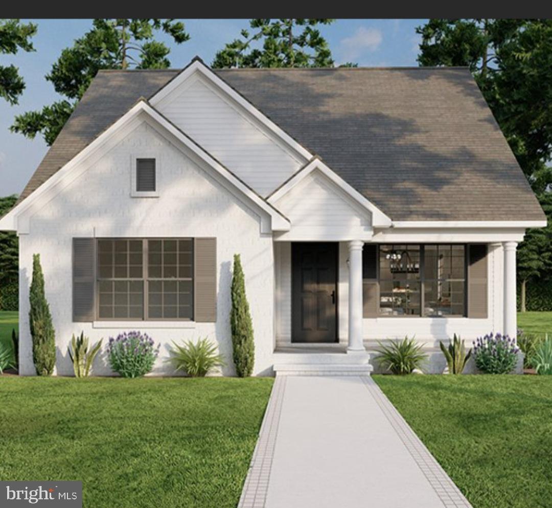 a front view of a house with a yard and potted plants