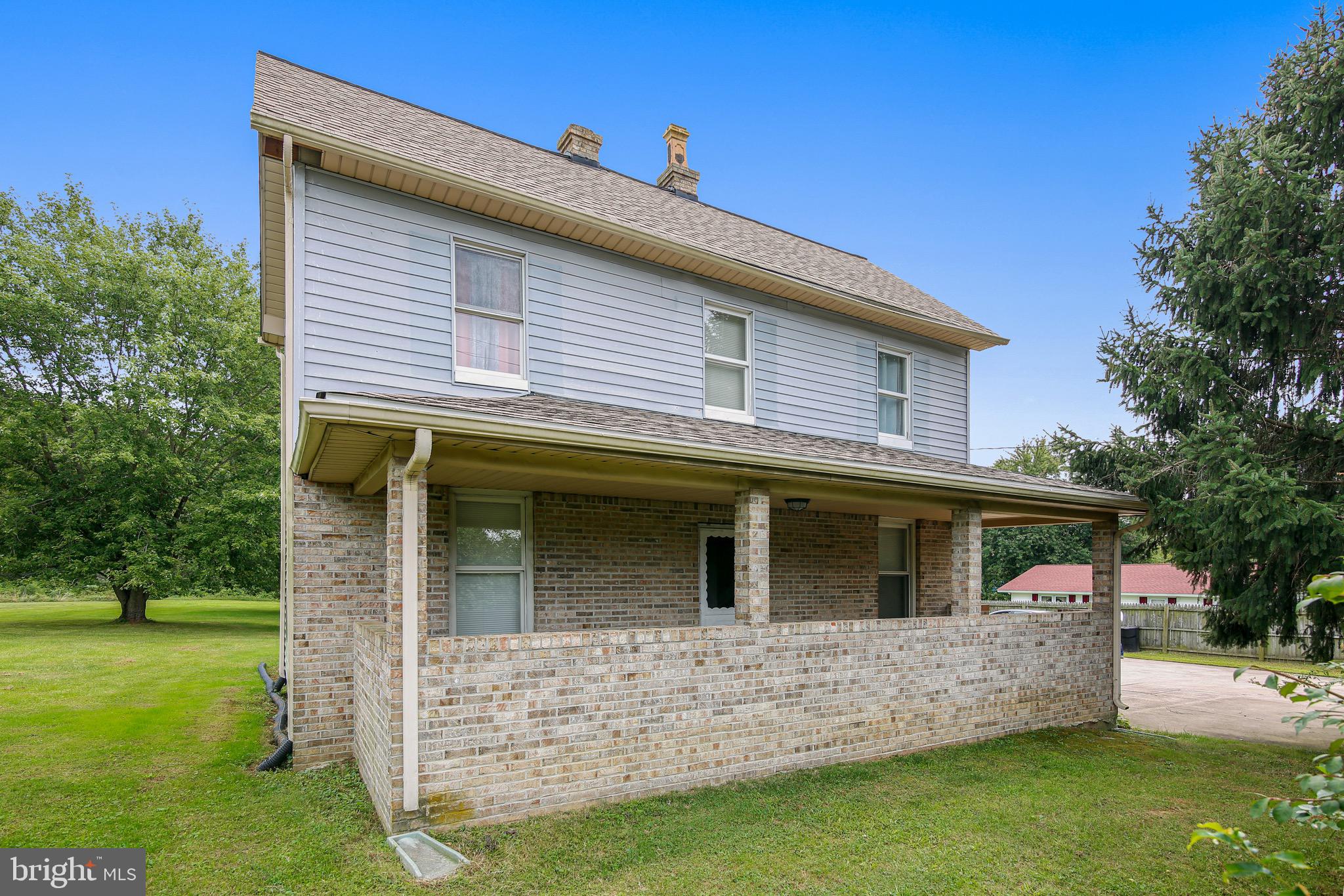 a view of house with a yard