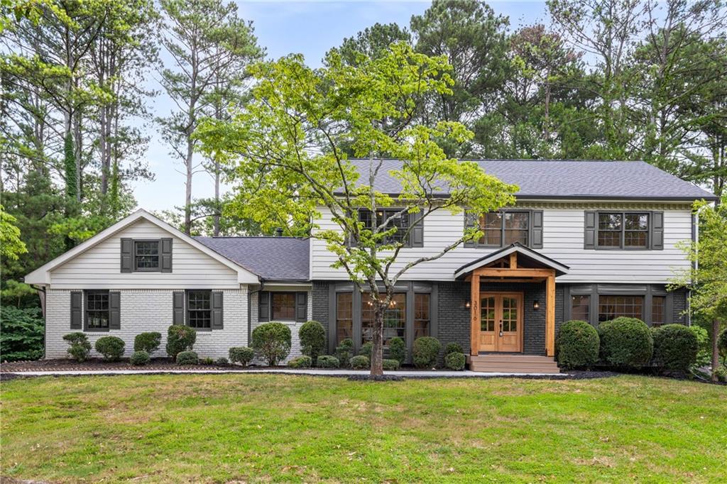 a front view of a house with a yard