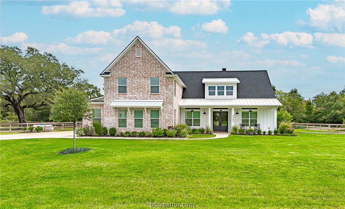 a front view of house with yard and green space