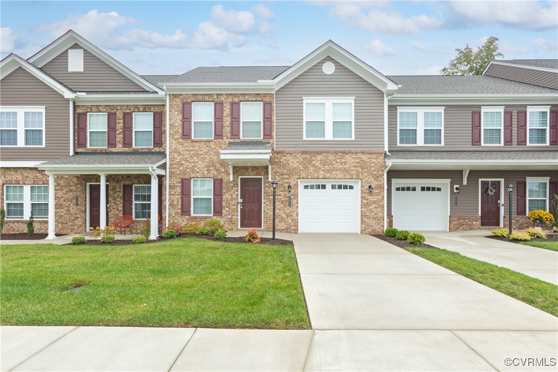 a front view of a brick house with a yard