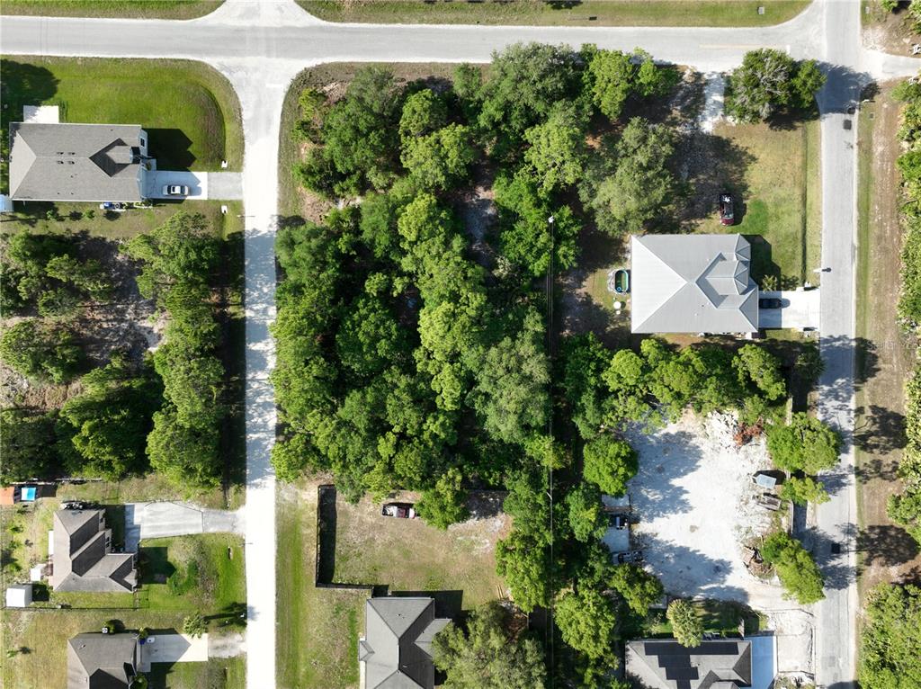 an aerial view of a house with swimming pool and garden