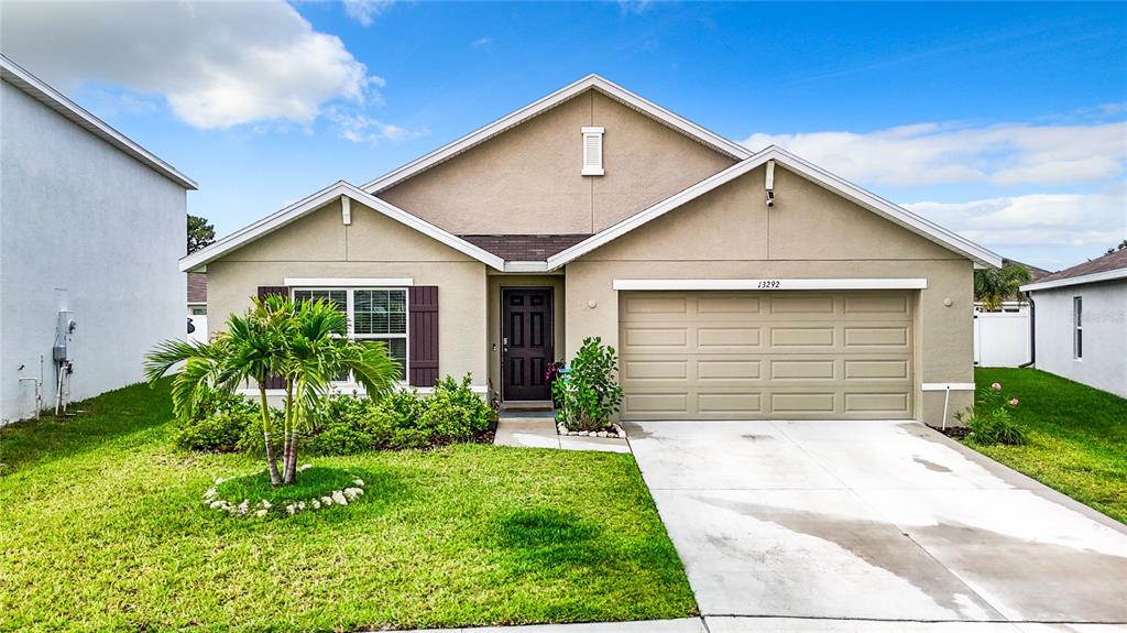 a front view of a house with a yard and garage