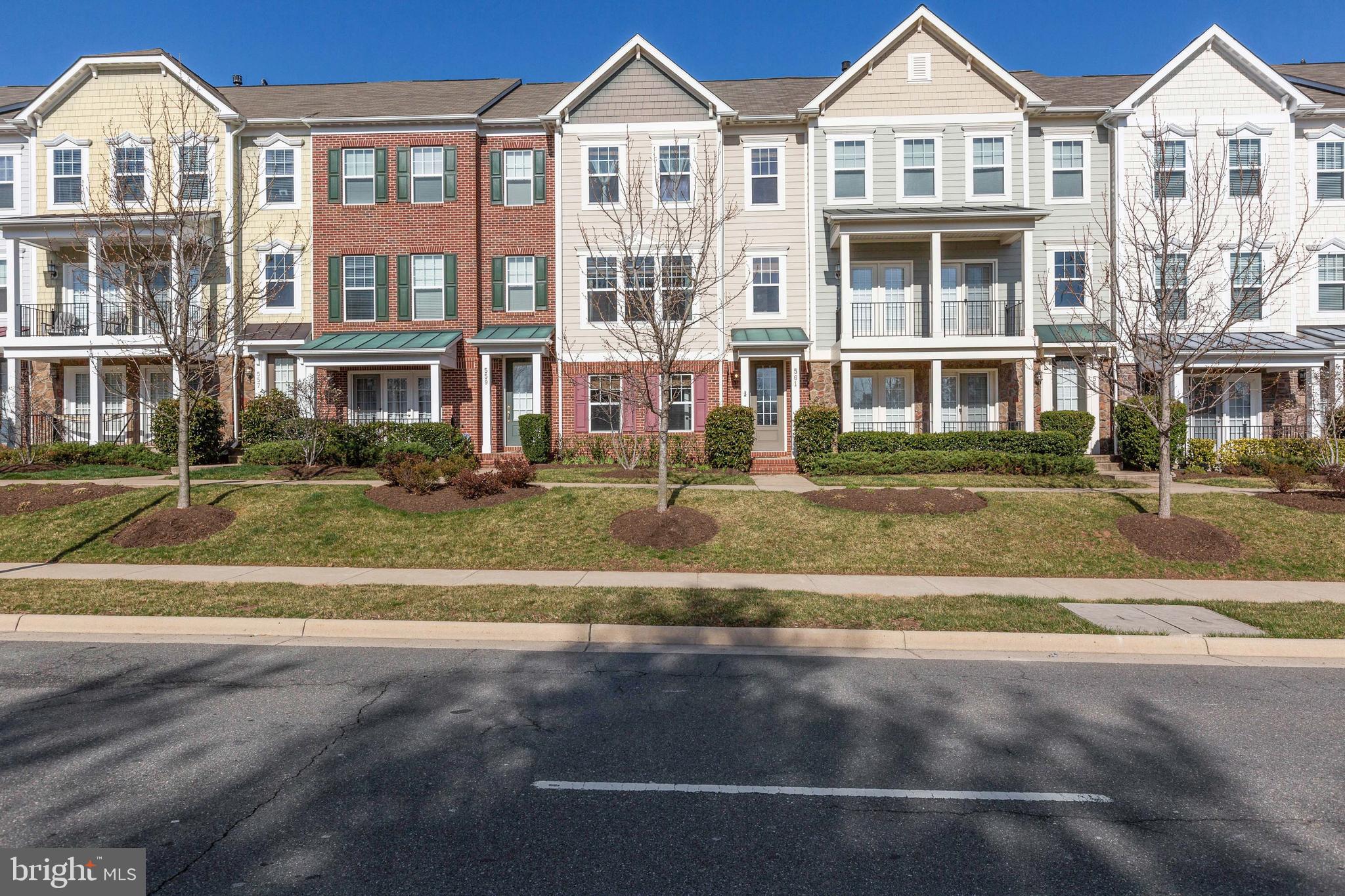 a front view of a residential apartment building with a yard