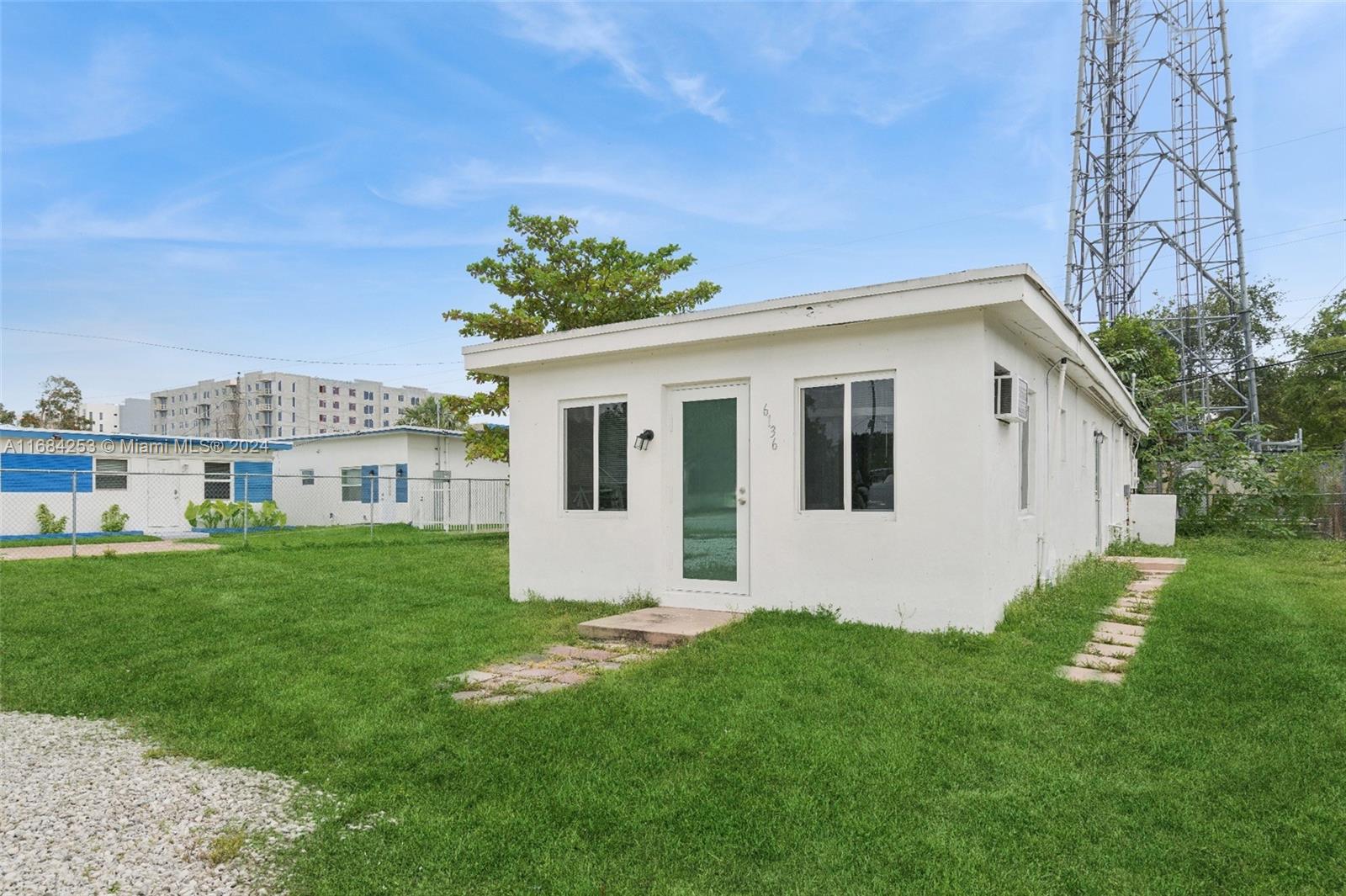 a view of a house with a backyard