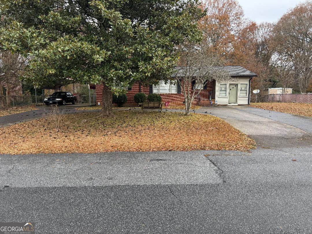 a front view of a house with a yard and a porch