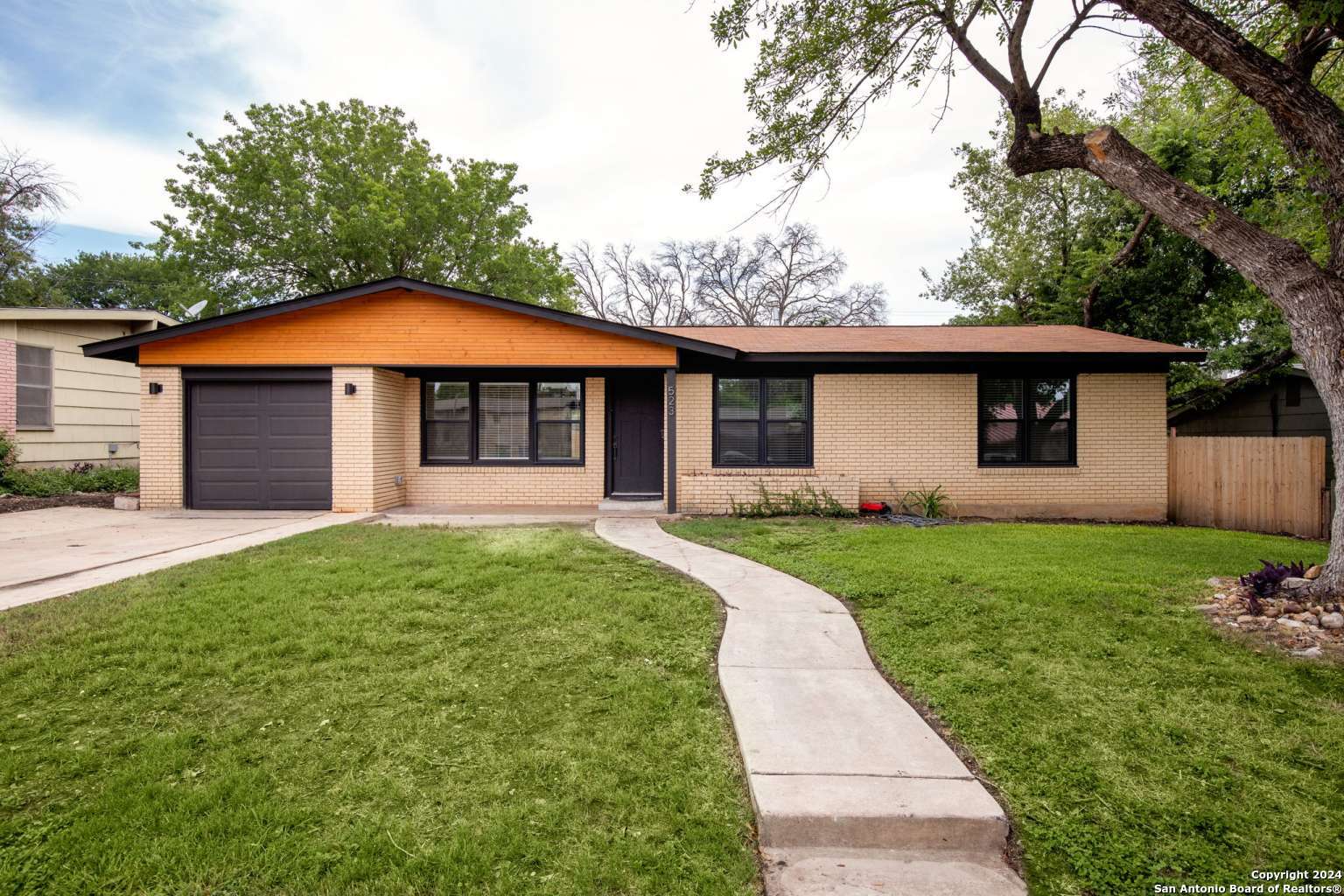 a front view of a house with a yard