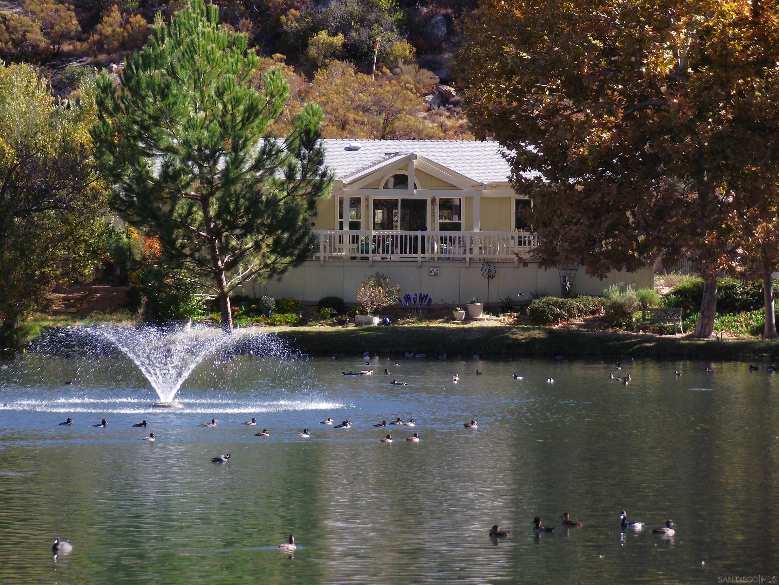 an aerial view of a house with a lake view