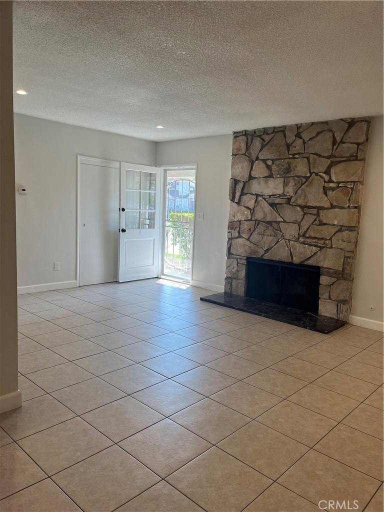 a view of an empty room and fire place