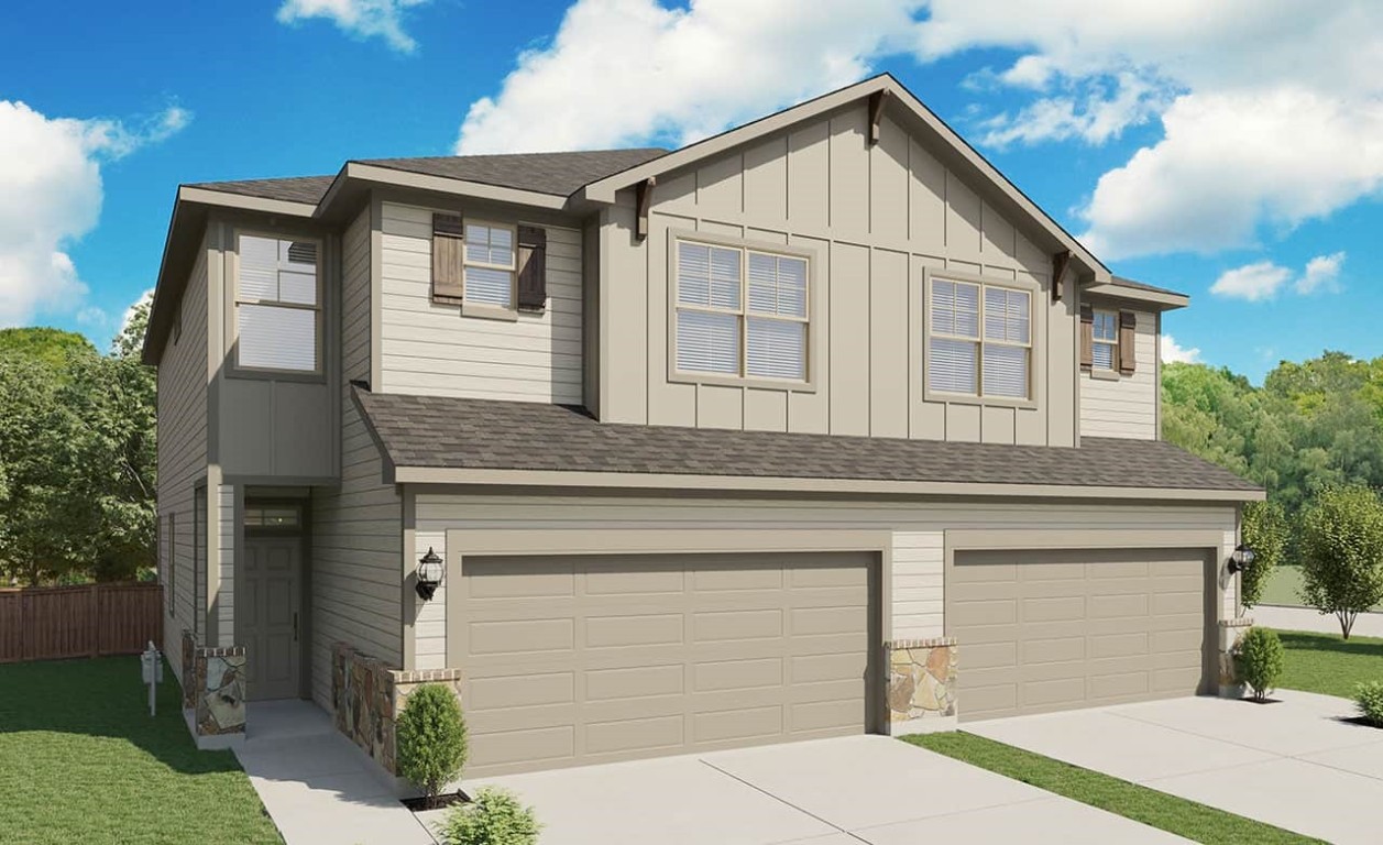 a view of a house with a garage and balcony