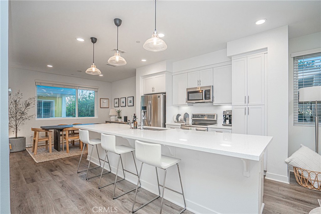 a large kitchen with kitchen island a dining table and chairs