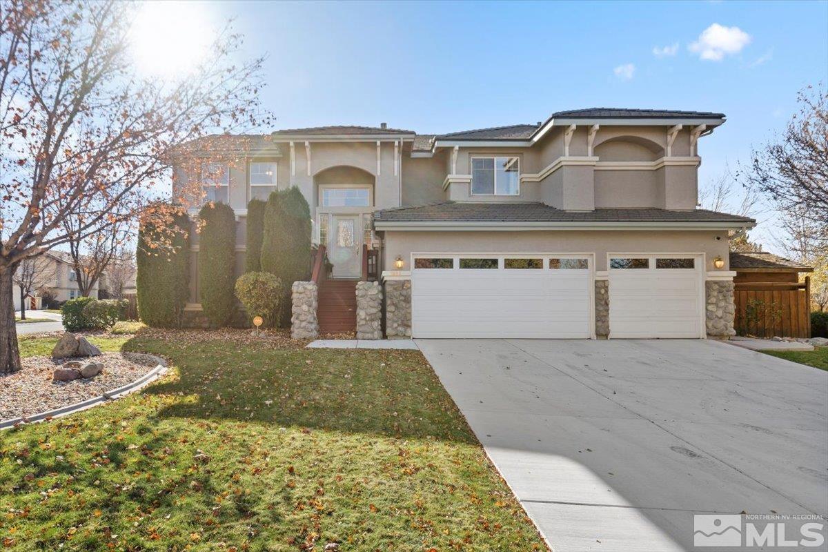 a front view of a house with a yard and garage