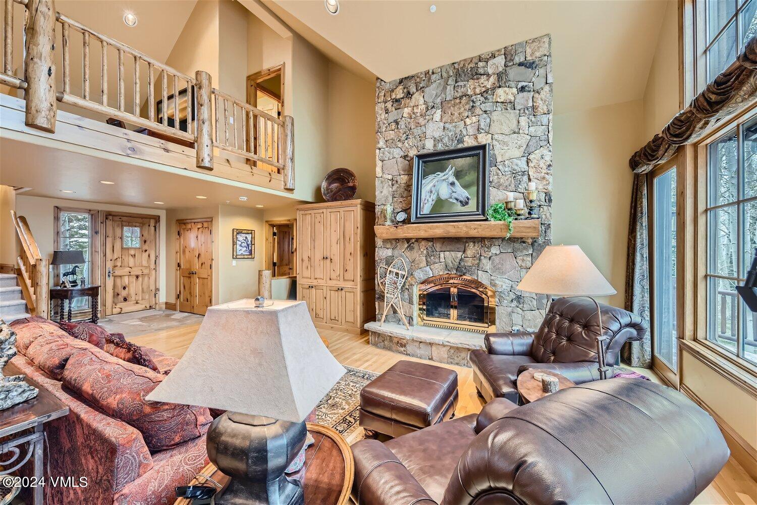 a living room with furniture a fireplace and a large window