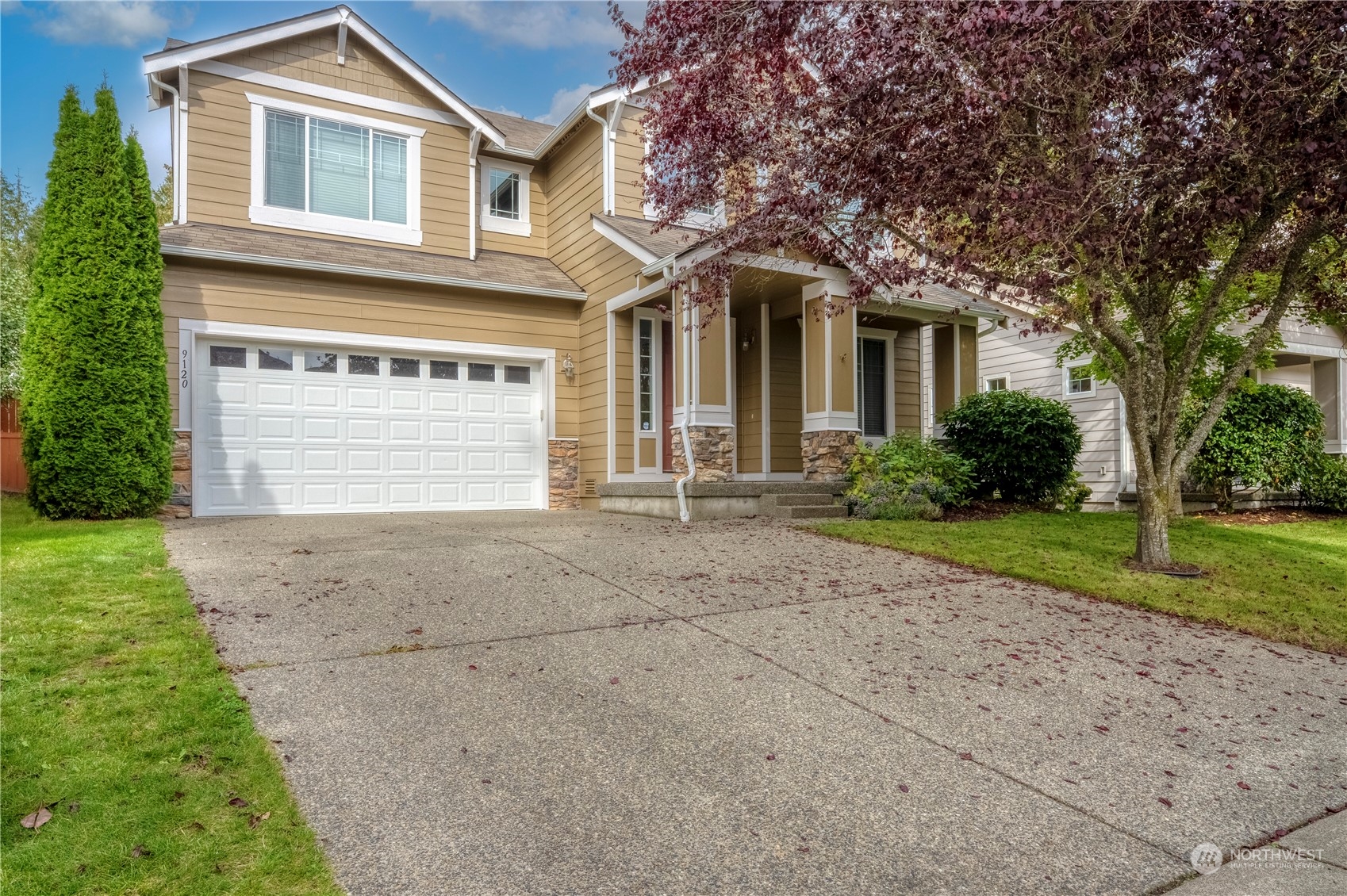 a front view of a house with a yard and garage