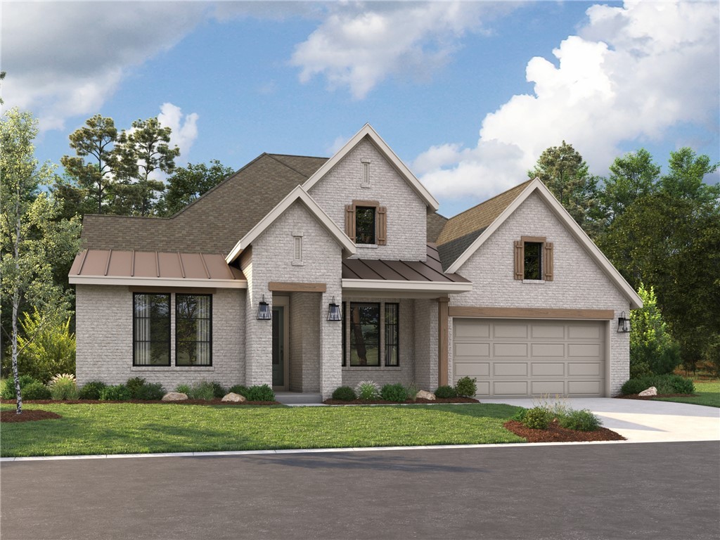 a front view of a house with a yard and a garage