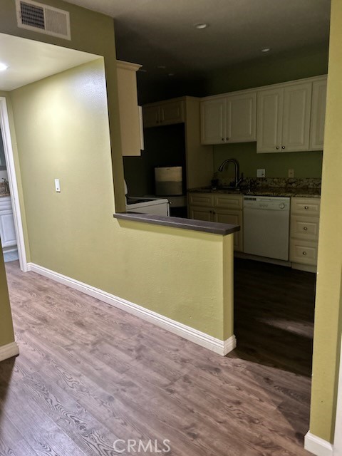 a kitchen with granite countertop wooden cabinets and a stove