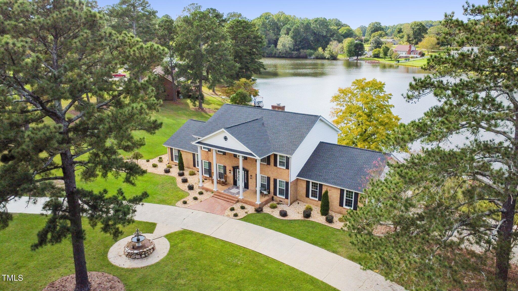 an aerial view of a house with garden space and street view