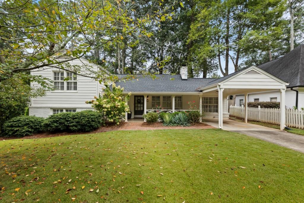 a front view of a house with a yard and porch