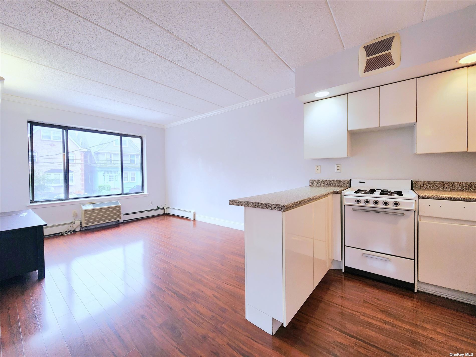 a kitchen with stove and cabinets