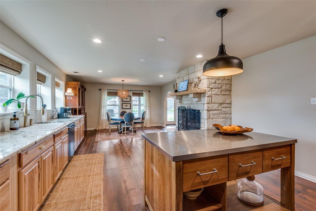 a open kitchen with stainless steel appliances granite countertop a stove and a sink