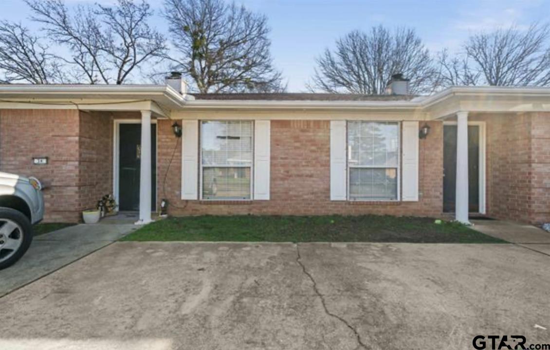 a view of a house with a yard and garage