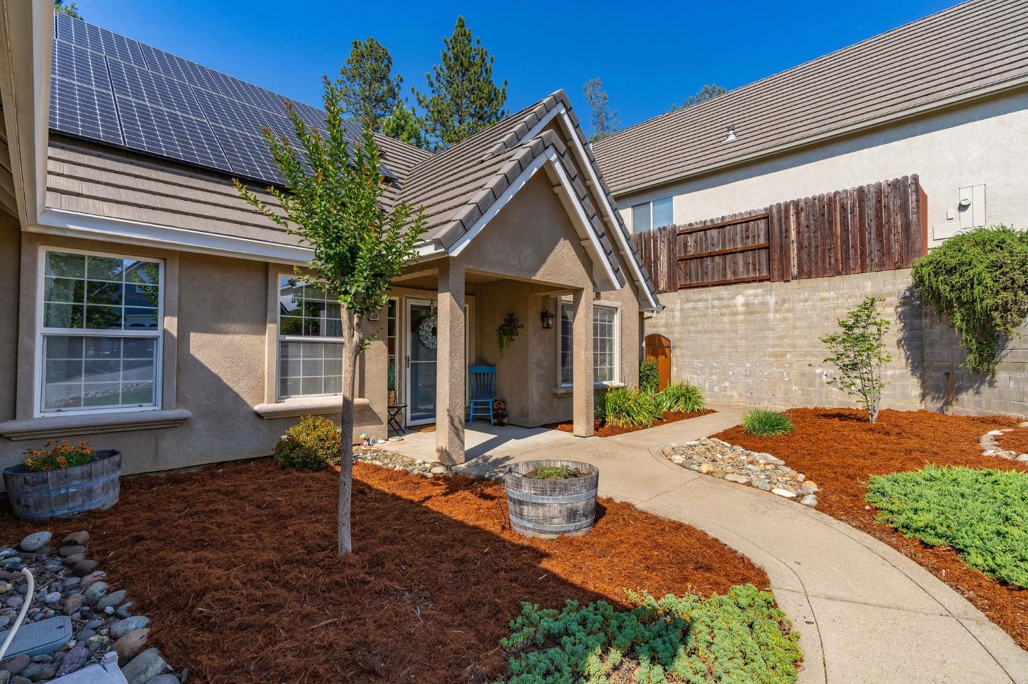 a front view of a house with garden