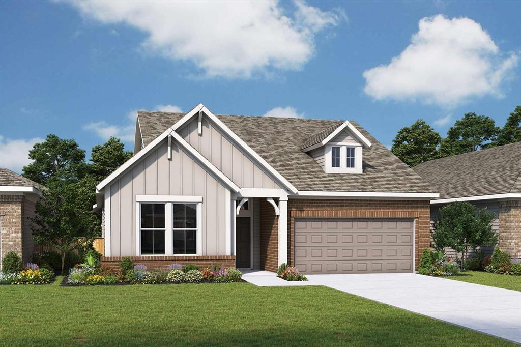 a front view of a house with a yard and garden