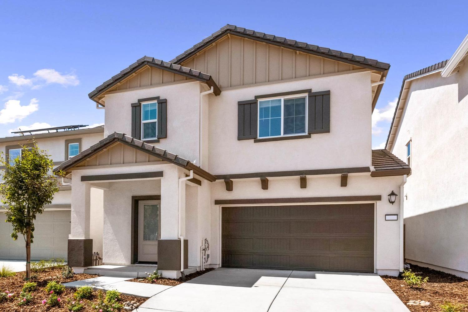 a front view of a house with a garage