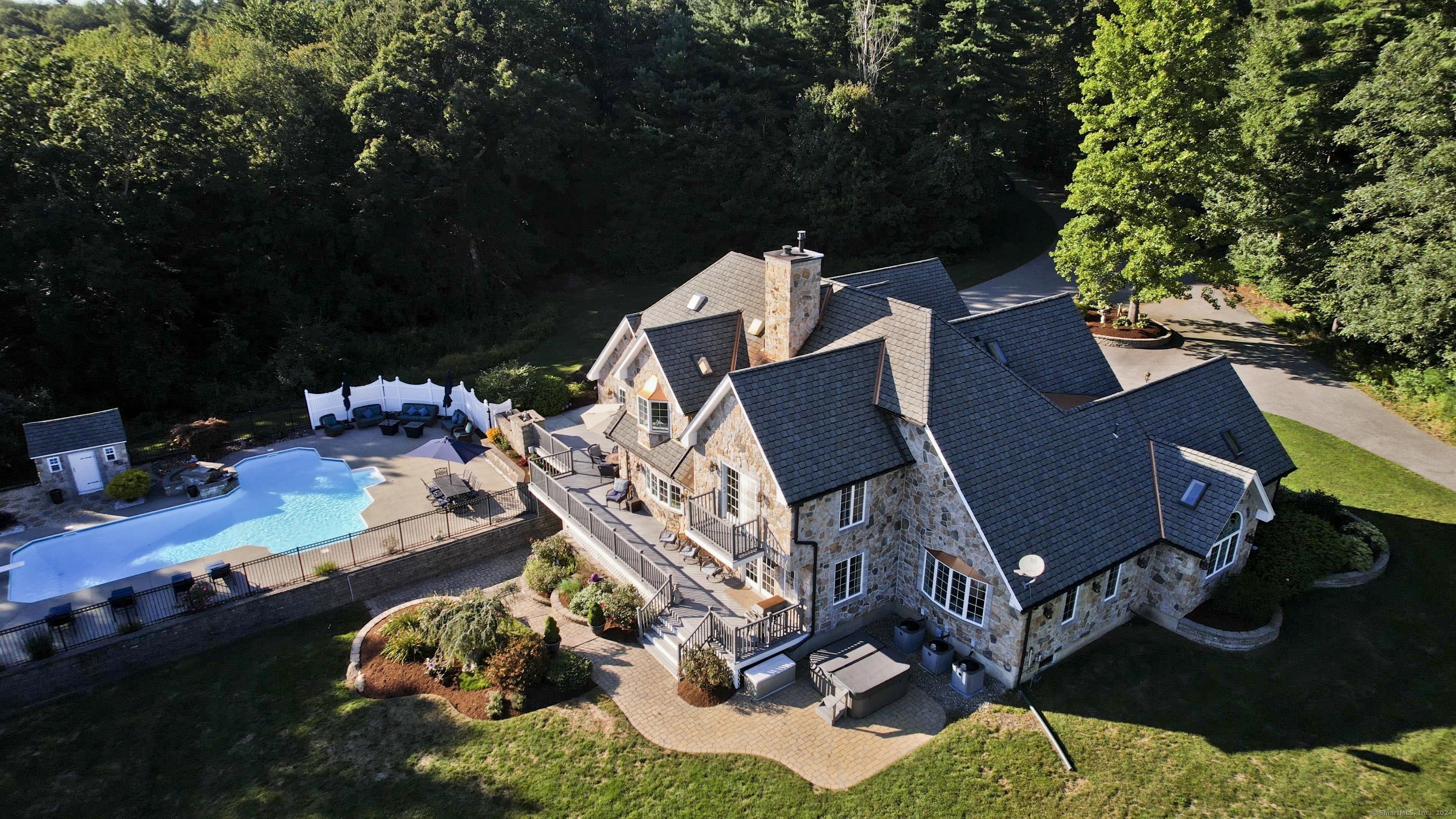 an aerial view of a house with a yard basket ball court and outdoor seating