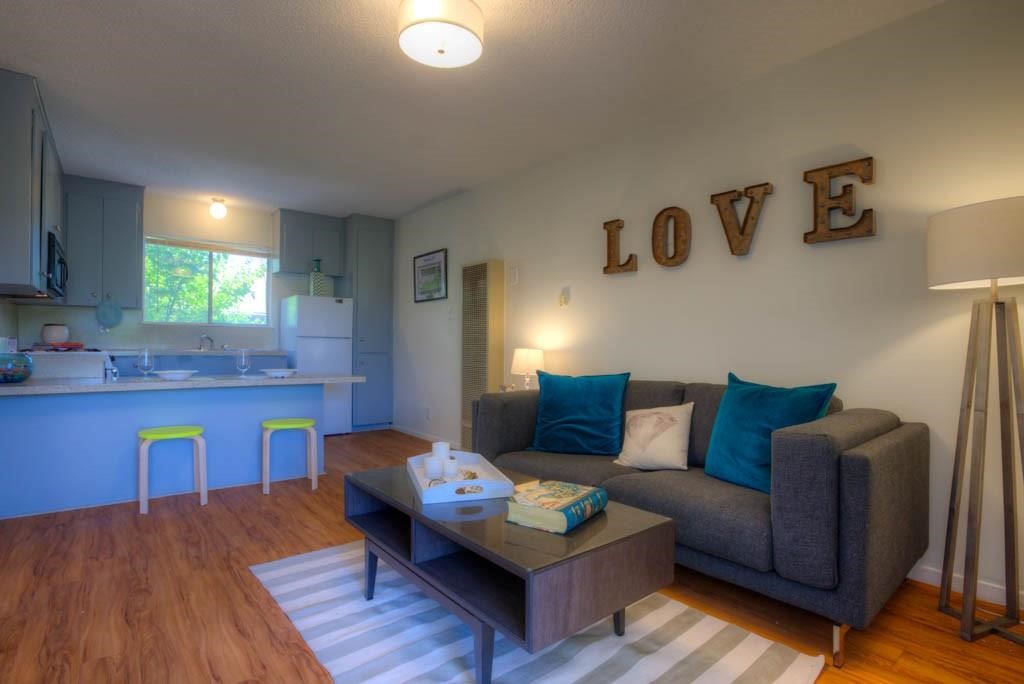 a living room with furniture and wooden floor