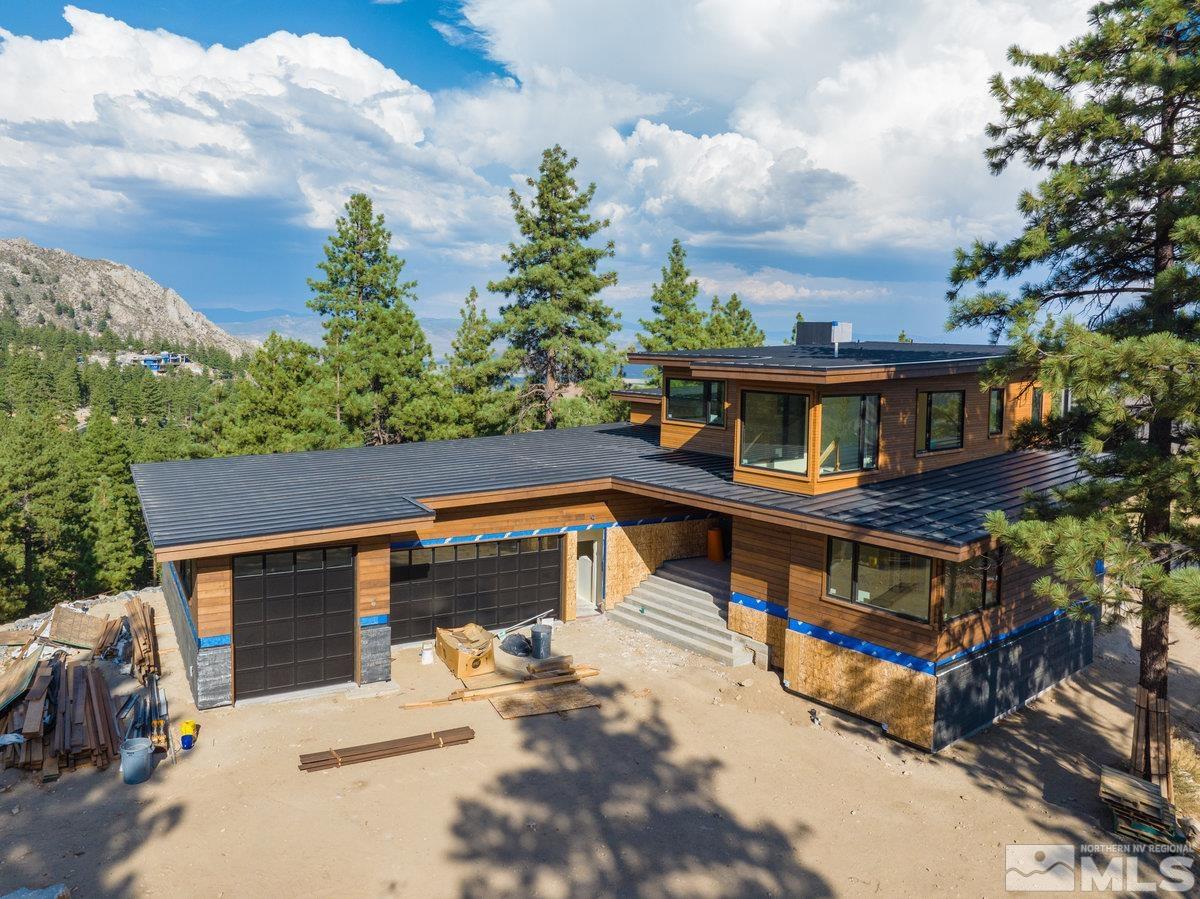 an aerial view of a house with balcony and trees