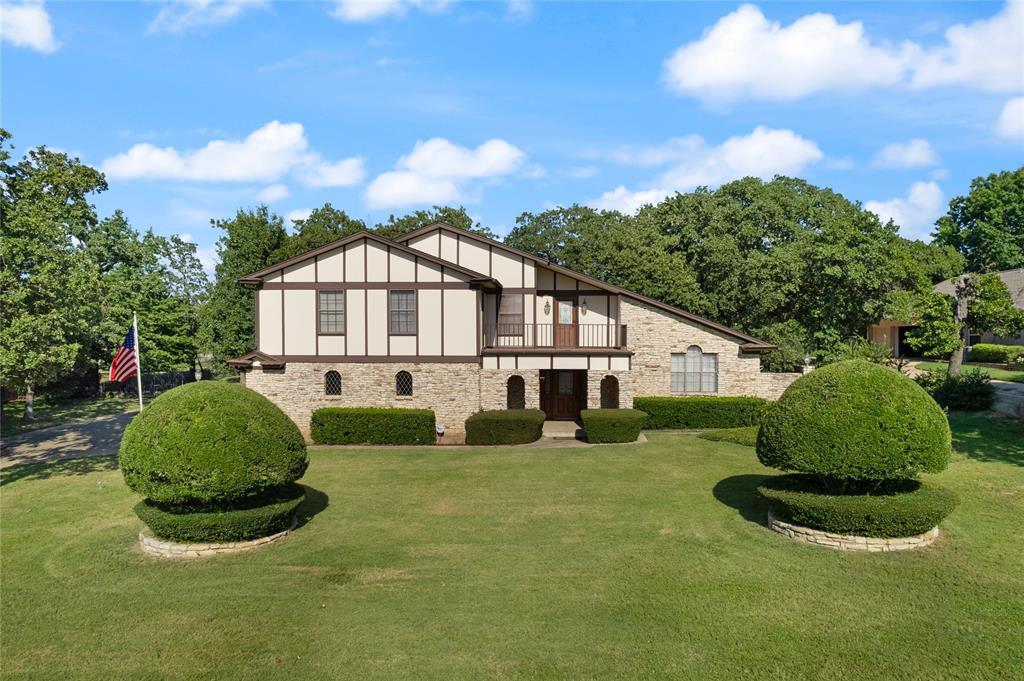 a view of a house with a backyard and porch