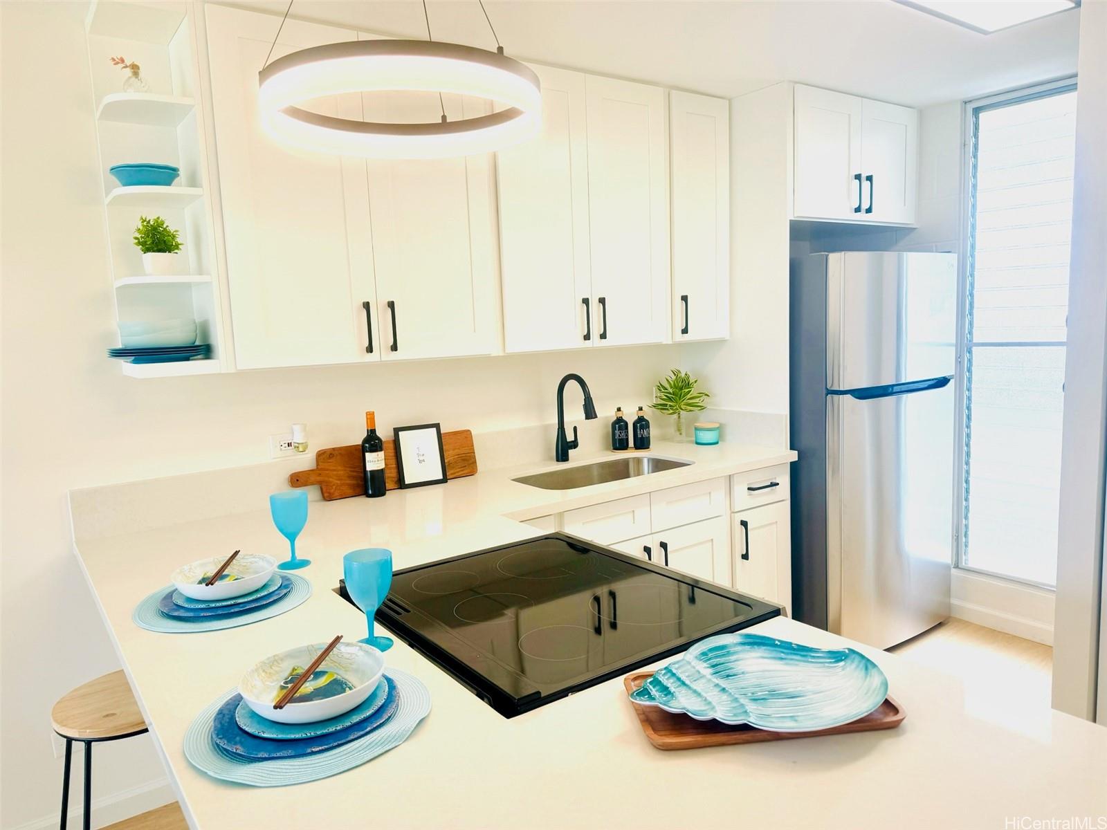 a kitchen with a refrigerator and a stove