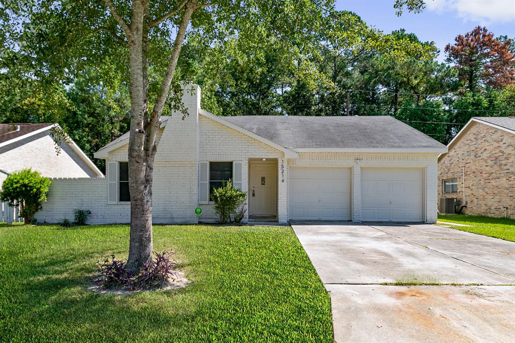 a aerial view of a house with a yard and garage