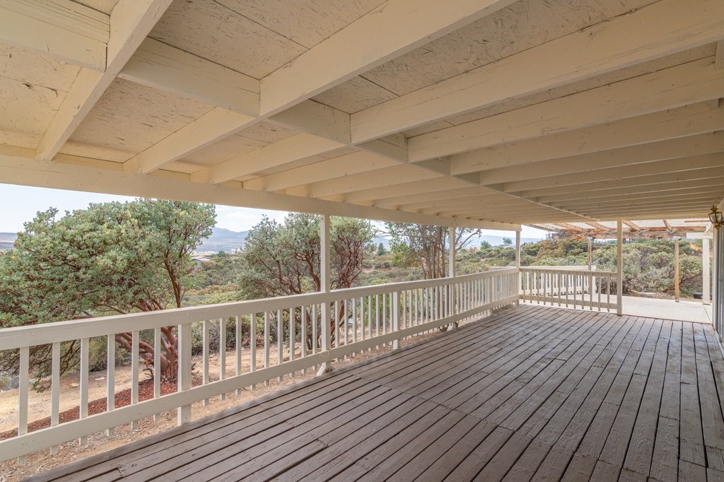 a view of a balcony with wooden floor