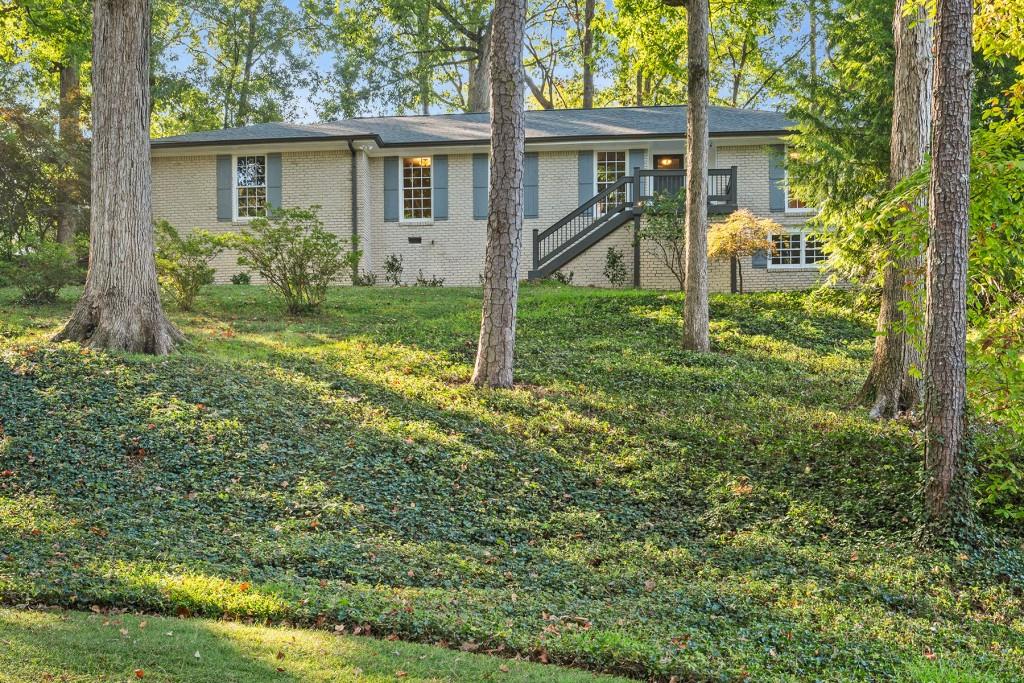 a view of a house with yard and a garden