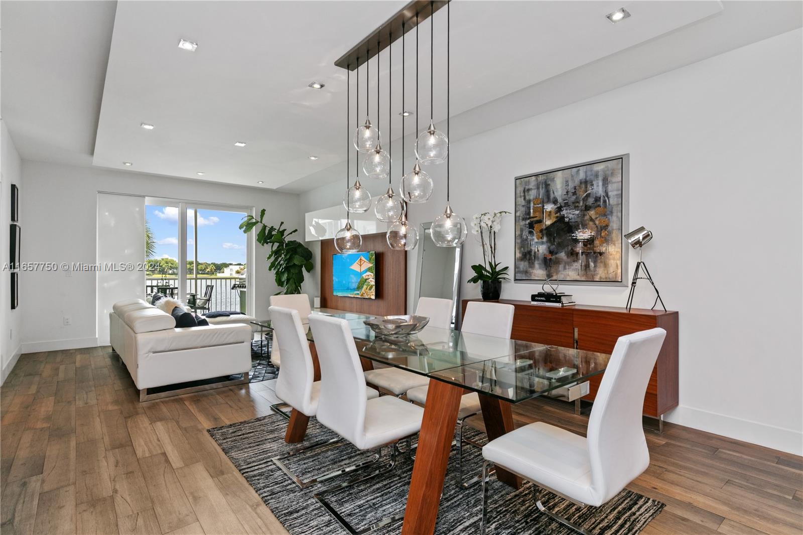 a view of a dining room with furniture a rug and wooden floor